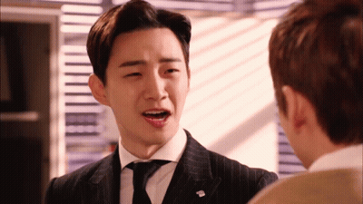 Man In Suit And Tie With T.M. Pin GIF