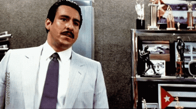 Man In Suit And Tie With Trophies GIF