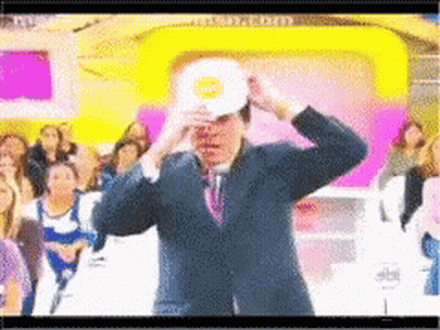 Man In Suit And Tie With White Hat And Sun GIF
