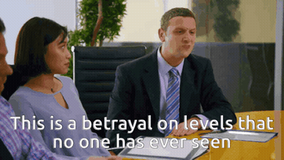 Man In Suit And Tie With Woman And Man In Blue Shirts GIF