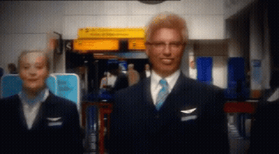 Man In Suit And Tie With Woman In Blue Uniform GIF
