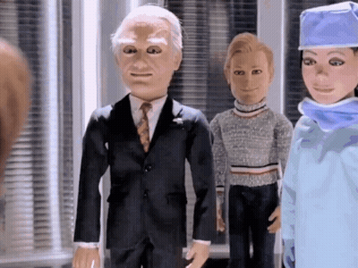 Man In Suit And Tie With Woman In Surgical Cap GIF