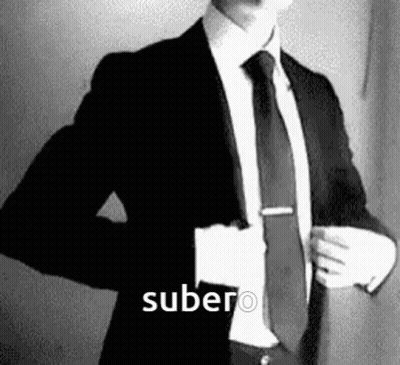 Man In Suit And Tie With Word Subero GIF