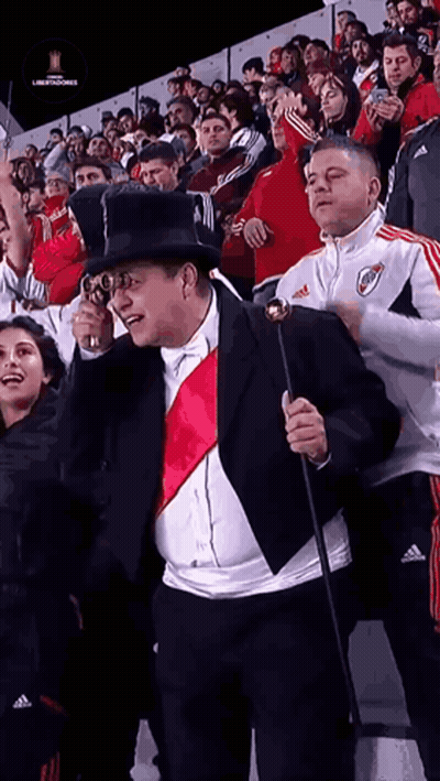 Man In Suit And Top Hat Holding Cane Before Crowd GIF