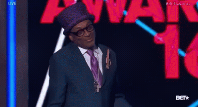 Man In Suit And Top Hat With Beta Awards Sign GIF