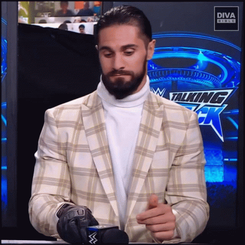 Man In Suit And Turtleneck At Diva Studios Sign GIF