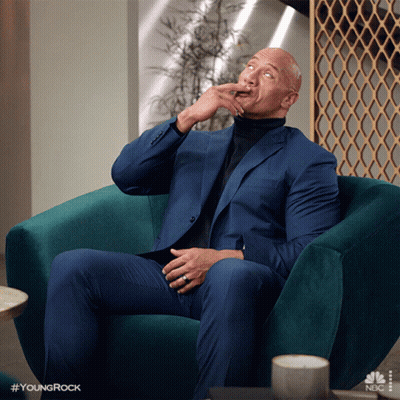 Man In Suit And Turtleneck In Green Chair Hashtag Youngrock GIF