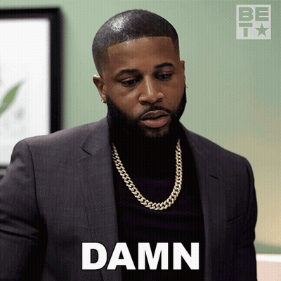 Man In Suit And Turtleneck Saying Damn GIF