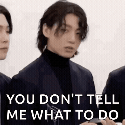 Man In Suit And Turtleneck Standing Next To Another Man GIF
