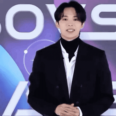 Man In Suit And Turtleneck With Love Sign GIF