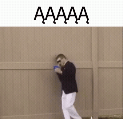 Man In Suit And White Pants Holding Blue Cup GIF