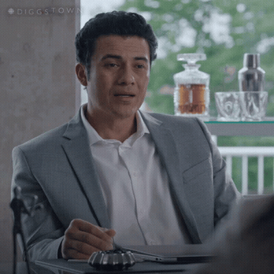 Man In Suit And White Shirt At Table GIF