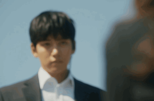 Man In Suit And White Shirt Looks At Another Man GIF