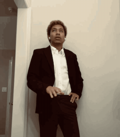 Man In Suit And White Shirt Standing Hallway GIF