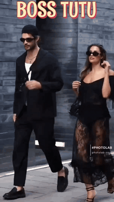 Man In Suit And Woman In Black Dress Walking Down Sidewalk Boss Tutu GIF