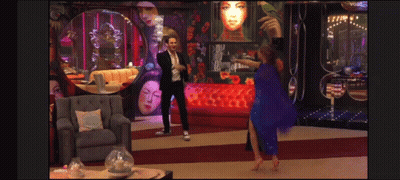 Man In Suit And Woman In Blue Dress Dancing In Living Room GIF