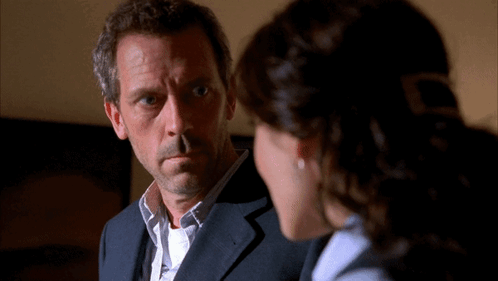 Man In Suit And Woman In Blue Shirt GIF