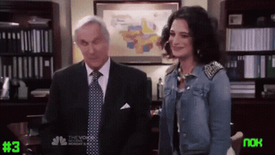 Man In Suit And Woman In Denim Jacket Next To #3 Screen GIF