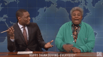 Man In Suit And Woman In Green Cardigan Sitting GIF