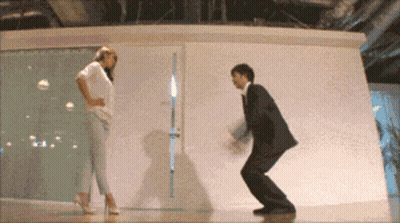 Man In Suit And Woman In High Heels Dancing GIF