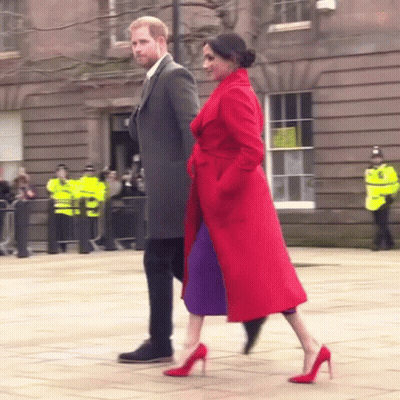 Man In Suit And Woman In Red Coat Walking GIF