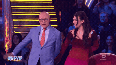 Man In Suit And Woman In Red Dress On TV Saying 5 HD GIF