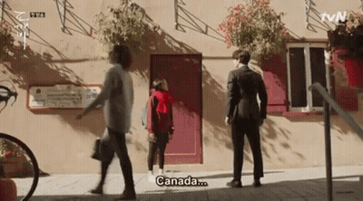 Man In Suit And Woman In Red Hoodie Saying Canada GIF