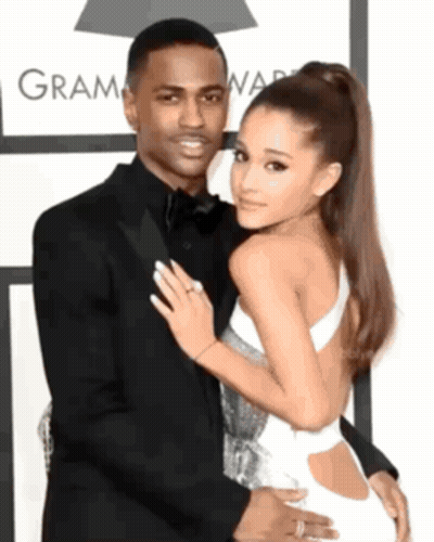 Man In Suit And Woman In White Dress At Grammy Awards GIF