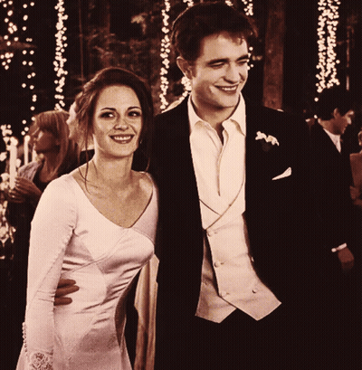 Man In Suit And Woman In White Dress Smile GIF