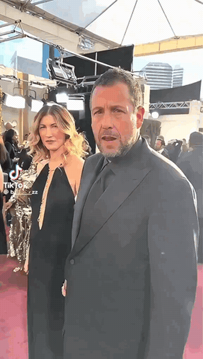 Man In Suit And Woman On Red Carpet GIF