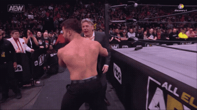 Man In Suit And Wrestler In AEW Ring GIF