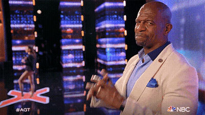 Man In Suit Applauding In Front Of NBC Sign GIF