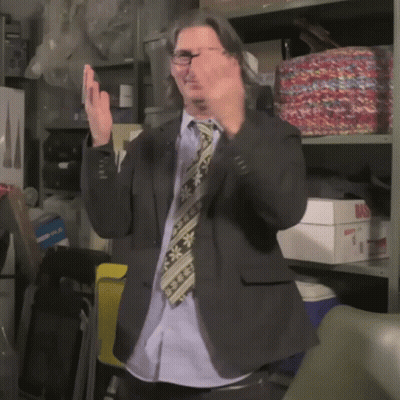 Man In Suit Applauding In Front Of Shelf Saying Bas GIF