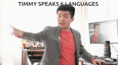 Man In Suit At Computer Saying Timmy Speaks 6 Languages GIF