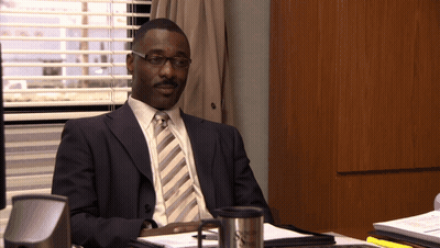 Man In Suit At Desk By Window With Blinds GIF