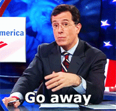 Man In Suit At Desk Saying Go Away GIF
