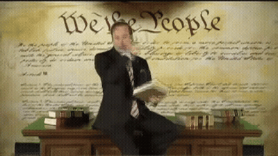 Man In Suit At Desk Saying We The People GIF