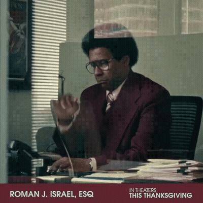 Man In Suit At Desk With Computer Saying Roman J. Israel Esq GIF
