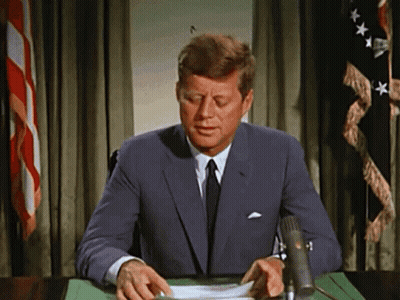 Man In Suit At Desk With Microphone GIF
