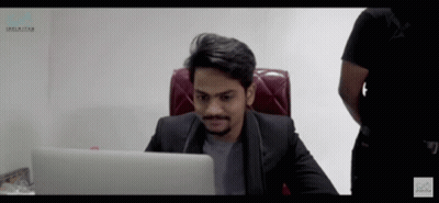 Man in Suit at Desk with Unlimited Laptop