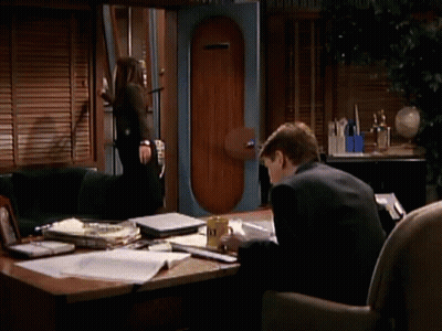 Man In Suit At Desk With Yellow A & N Mug GIF