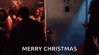 Man In Suit At Door In Crowded Room GIF