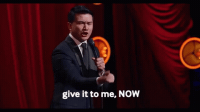 Man In Suit At Mic Says Give It To Me Now GIF