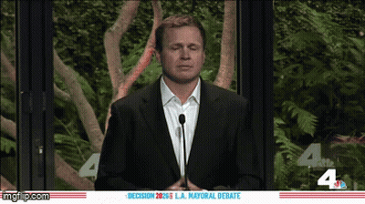 Man In Suit At Microphone Debate GIF