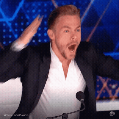 Man In Suit At Microphone Hands Up GIF