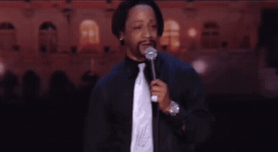 Man In Suit At Microphone On Stage GIF