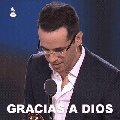Man In Suit At Microphone Saying Gracias A Dios GIF