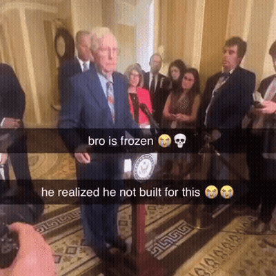 Man In Suit At Podium Bro Is Frozen GIF