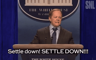 Man In Suit At Podium Saying Settle Down GIF