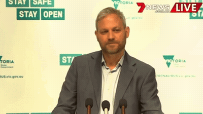 Man In Suit At Podium Saying Stay Safe GIF